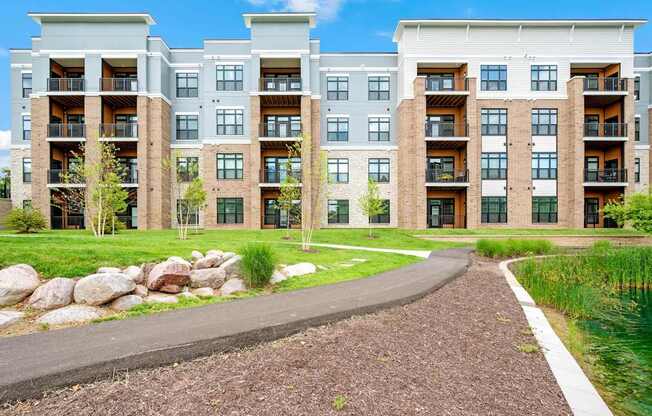 A modern apartment complex with a walkway in front.