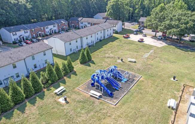 an aerial view of the playground and houses