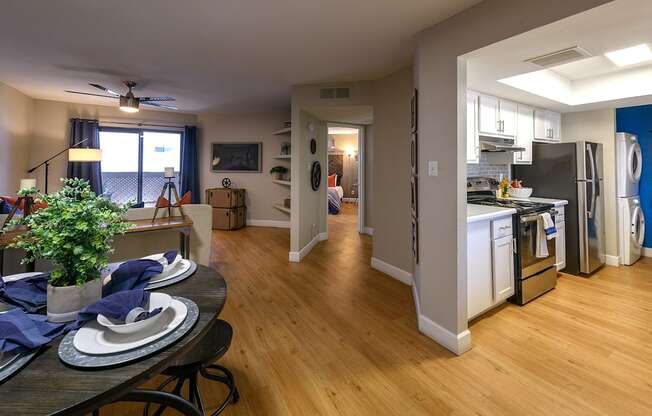 an open kitchen and living room with a dining room table