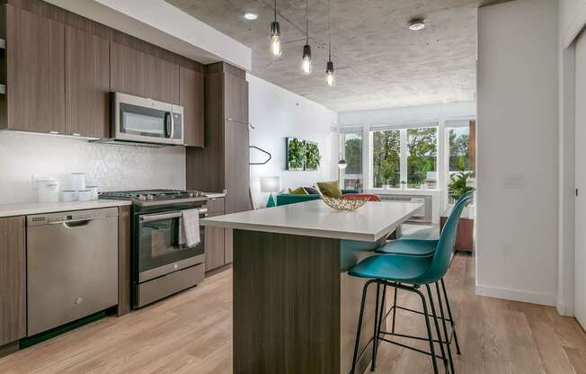 A kitchen with a white counter top and a blue chair.