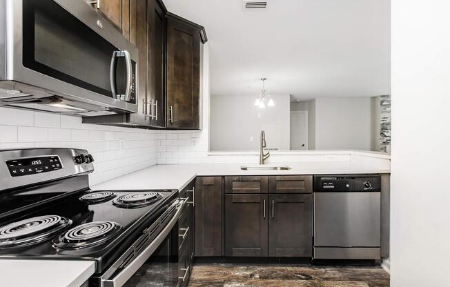 a stove top oven sitting inside of a kitchen