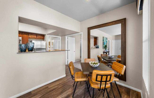 A dining room with a table and chairs.