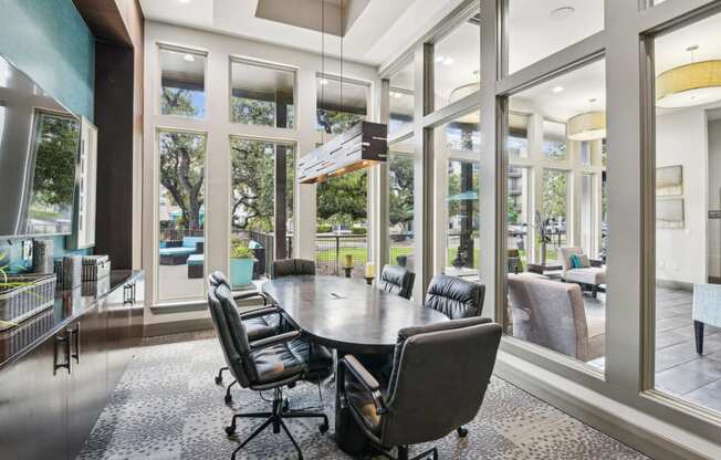 a conference room with large windows and a table and chairs