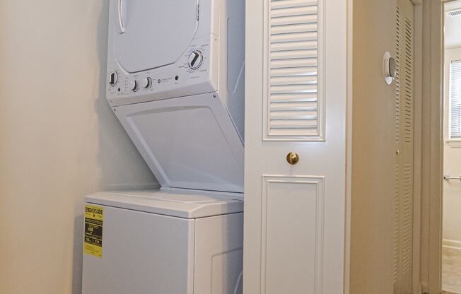 the laundry room has a washer and dryer and a door to the closet