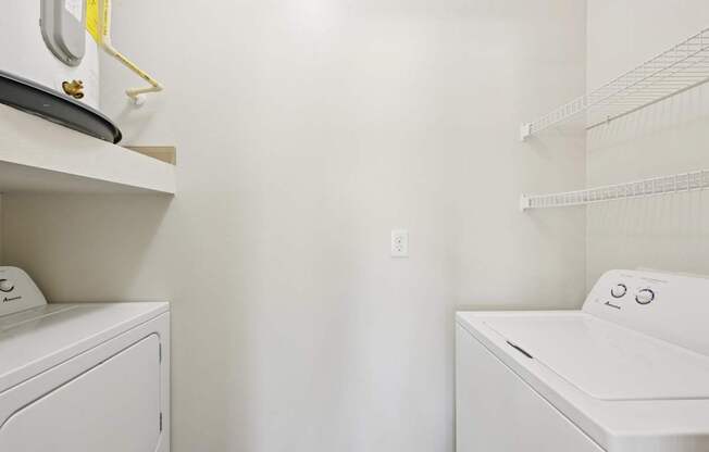 A white washing machine and dryer in a laundry room.