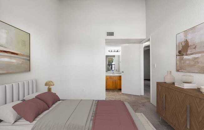 A bedroom with a large bed and a painting on the wall.