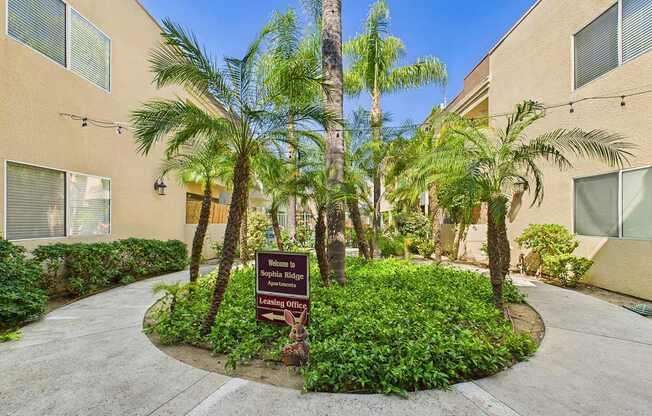 A sign in front of a building that says "Leasing Office".