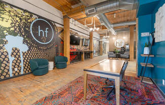 a room with a ping pong table and chairs