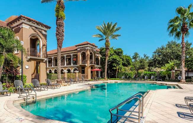 Resort pool with sundeck seating and tropical landscaping for ultimate relaxation.