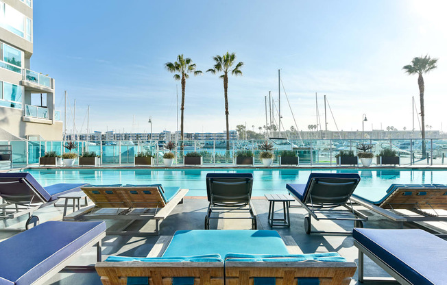 A pool area with sun loungers and palm trees at Esprit Marina del Rey, 90292