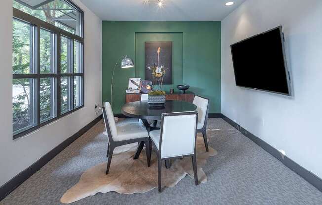 a dining room with a table and chairs and a television at The Hendrix, Atlanta, GA, 30329