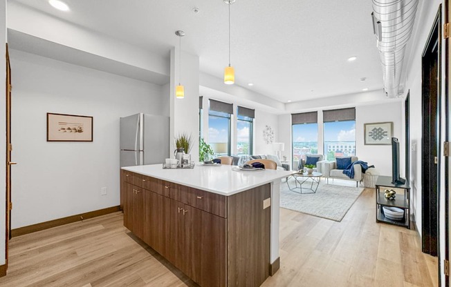 a kitchen with a large island and a living room