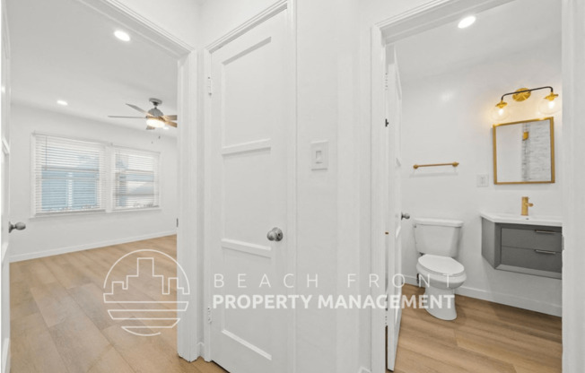 a bathroom with a toilet and a sink and a white door