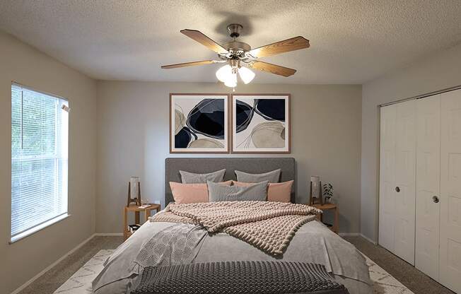 a bedroom with a ceiling fan and a bed