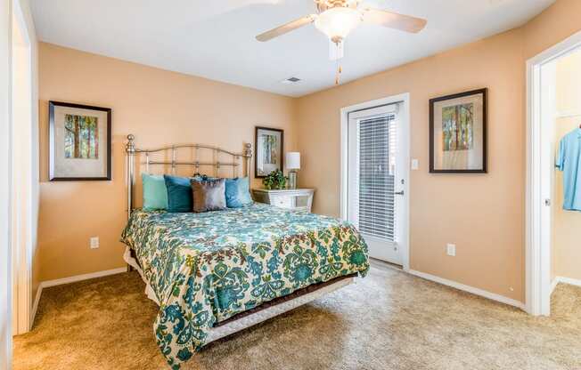 a bedroom with a bed and a ceiling fan