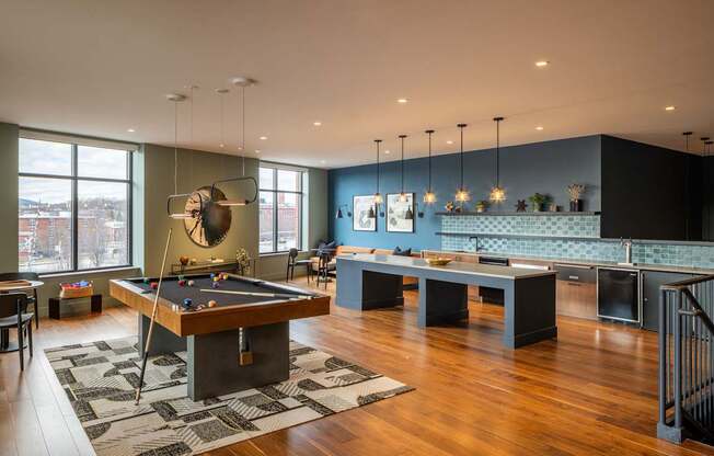 A room with a pool table and a bar.