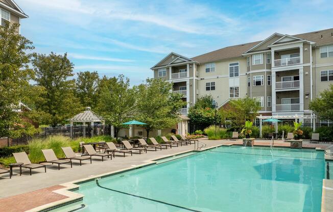 Resort-style pool with expansive sundecks, shaded lounge areas, and landscaped surroundings designed for refreshing swims and relaxed afternoons outdoors.