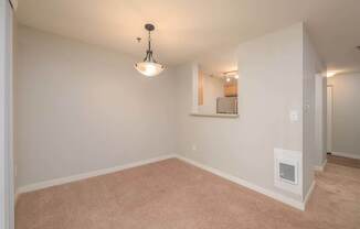 A room with a carpet floor and a ceiling light.