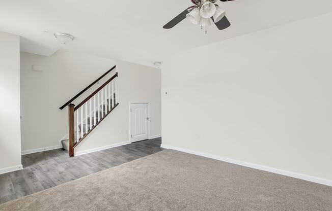 Living room with a ceiling fan and a staircase at Hudson Ridge, Red Lion, Pennsylvania.