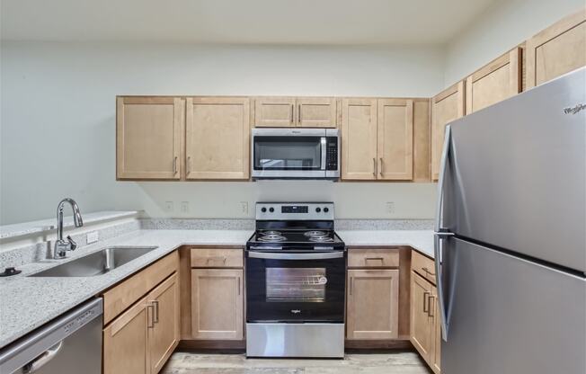 a kitchen with stainless steel appliances and wooden cabinets