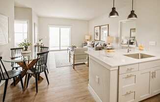 an open kitchen and living room with a dining room table and chairs at 44 West Luxury Living, Valley Park, 63088