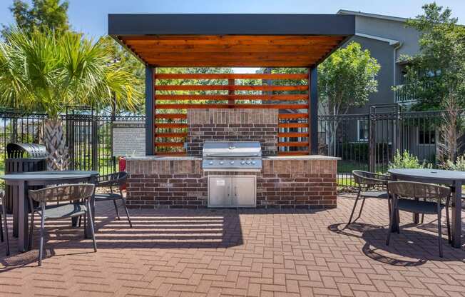 a patio with a grill and a table and chairs at Sladestone Shadow Creek, Pearland, TX, 77584