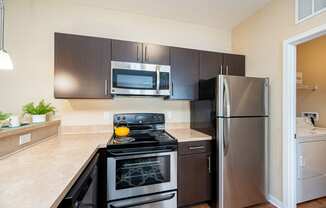 a kitchen with stainless steel appliances and a stainless steel refrigerator