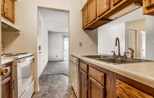 A kitchen with wooden cabinets and a white countertop