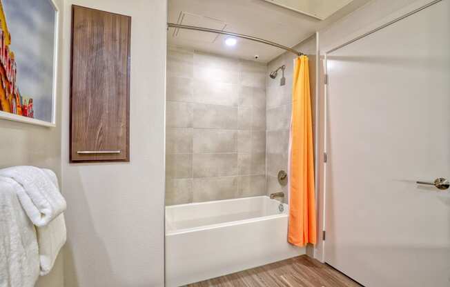 a bathroom with a shower and a tub and a white door