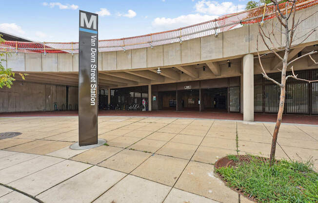 A sign for Van Dorn Street Station is in front of a concrete building.