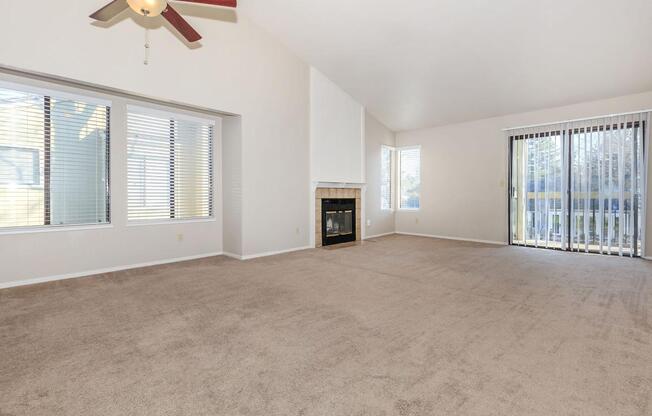 a living room filled with furniture and a large window