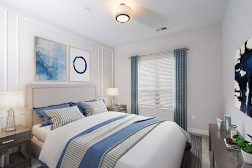 a bedroom with a large bed and two night stands with lamps at Fairfax, Grandview, OH