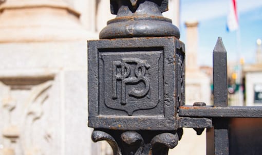 a black iron fence with a letter d on it