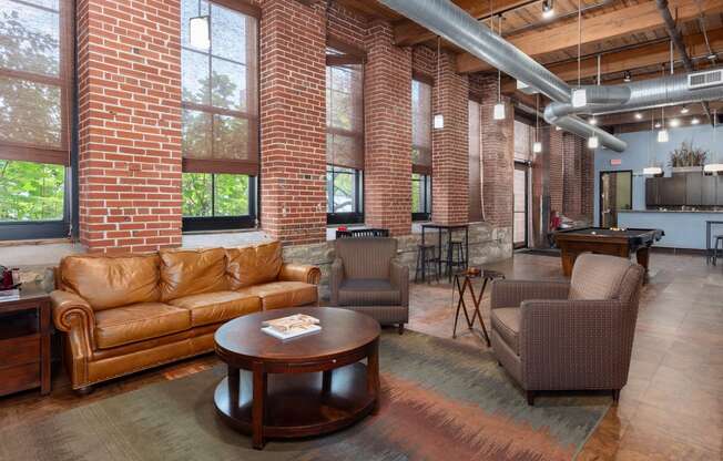 a living room with couches and chairs and a table