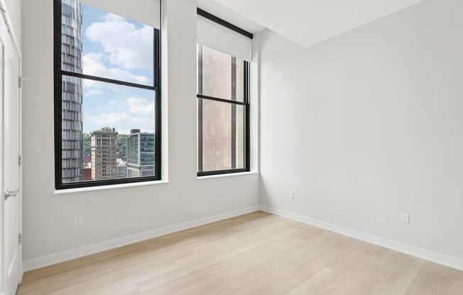 A room with a large window and a door.