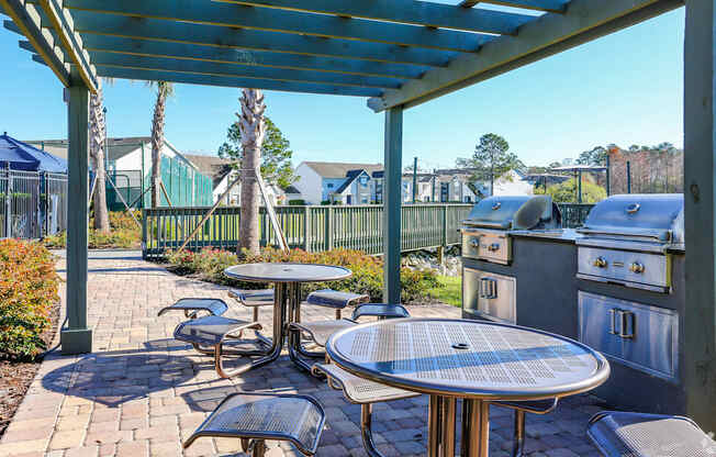 A patio with a table and chairs under a blue roof.