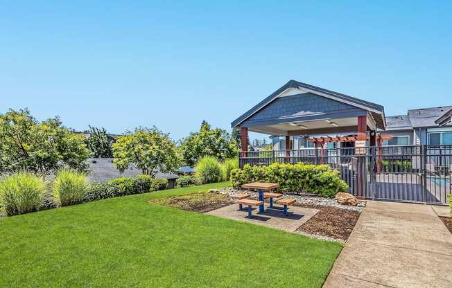 A picnic table and swimming pool gate exterior at The Landing Apartments and Townhomes, Oregon, 97045