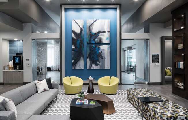 a living room with a blue wall and a couch and tables