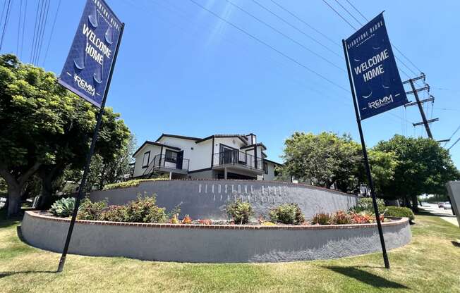 a retaining wall with flags in front of a house