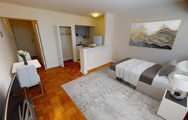 A bedroom with a bed, chair, and painting on the wall.