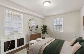 A bedroom with a bed, nightstand, and window with blinds.