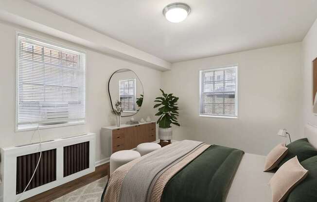 A bedroom with a bed, nightstand, and window with blinds.