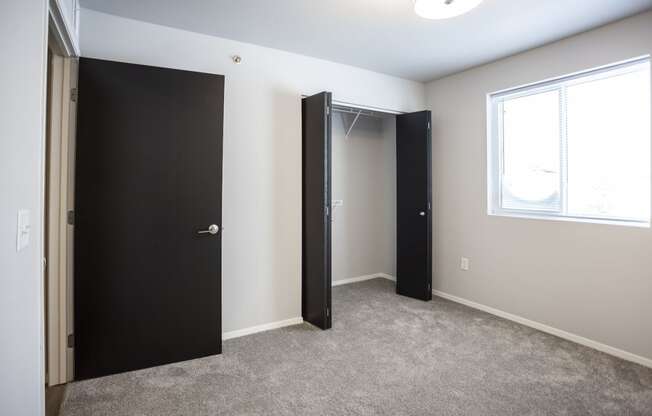 Spacious bedroom with neutral walls and ample natural light.