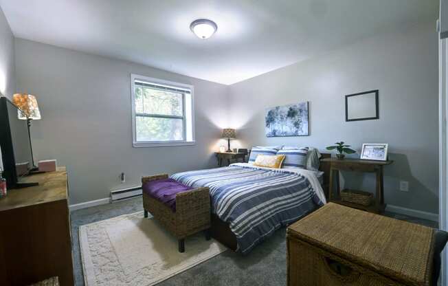 a bedroom with a bed and a dresser and a window