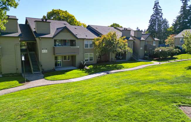 a row of houses on a green lawn