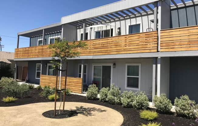 a view of the front of a building with a tree in front of it