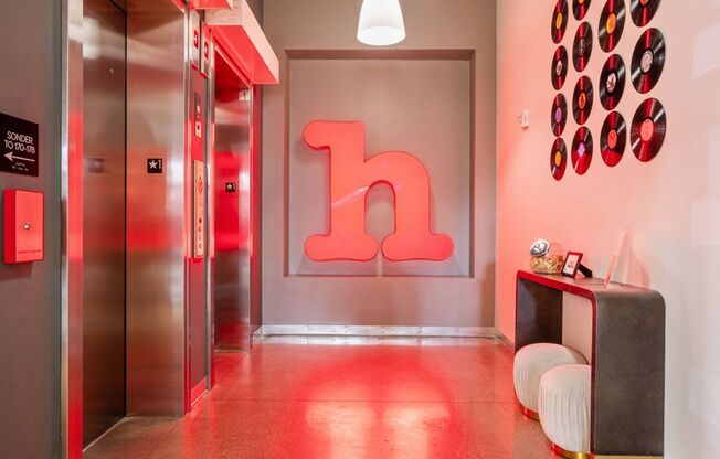 A hallway with a large letter h on the wall.
