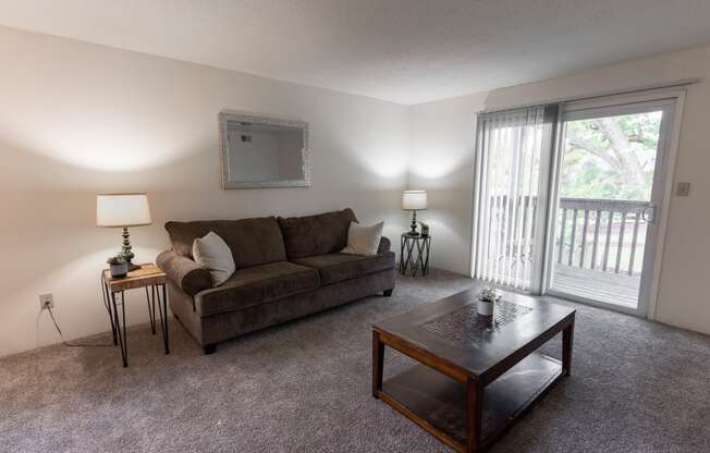 Living Room With Balcony at Candlewyck Apartments, Kalamazoo, MI