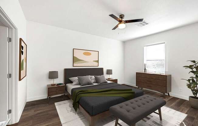 A bedroom with a bed, nightstand, and a plant.