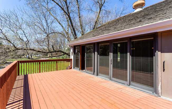 a large deck with sliding glass doors to the backyard  at ReNew at Neill Lake, Eden Prairie, 55344